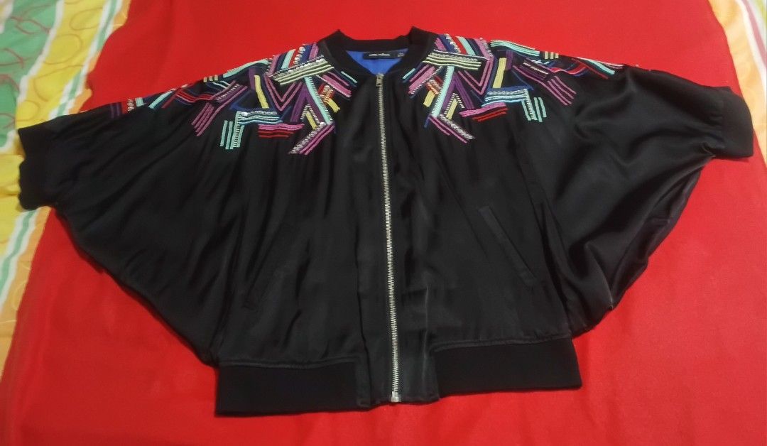 Emma Wallace Black Bomber Jacket with Multi-color Embroidery (Category: Coats, Jackets and Outerwear) located in Las Pinas. Submitted by marichelle1012 (Listing ID 1465846087, Image 1). Description: - Brand: Emma Wallace - Size: UK 8 / US 4 / EU 36 - Color: Black with vibrant multi-color shoulder embroidery and bright blue lining - Design: Full front zip, ribbed cuffs and hem, relaxed batwing sleeves - Condition: Excellent.