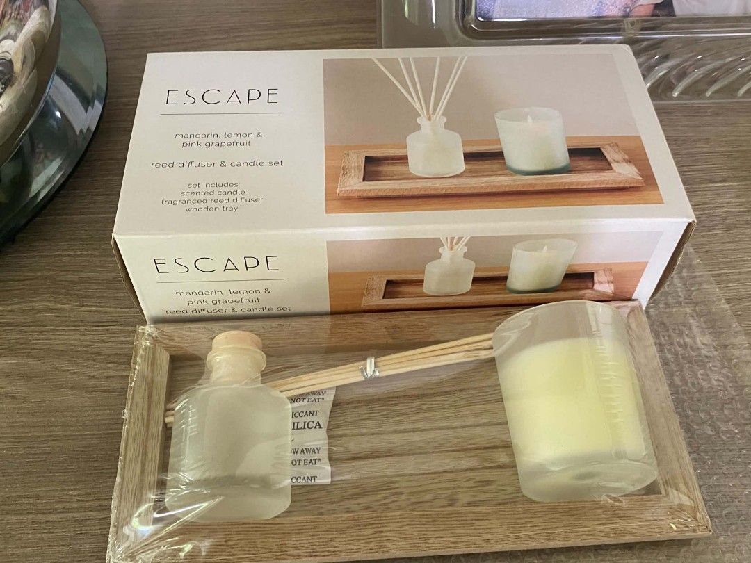 ESCAPE Reed Diffuser Candle Set (Category: Home Fragrance) located in Makati City. Submitted by larasdowry (Listing ID 1465946708, Image 1). Description: - Brand: Escape - Scent: Mandarin, Lemon, and Pink Grapefruit (Fresh & Citrusy) - Condition: Brand new, unopened, and sealed in original plastic wrapping with box - Inclusions: Scented candle, fragranced reed diffuser, wooden tray, and reeds - Perfect for: Home decor or ready-to-give gifting - E