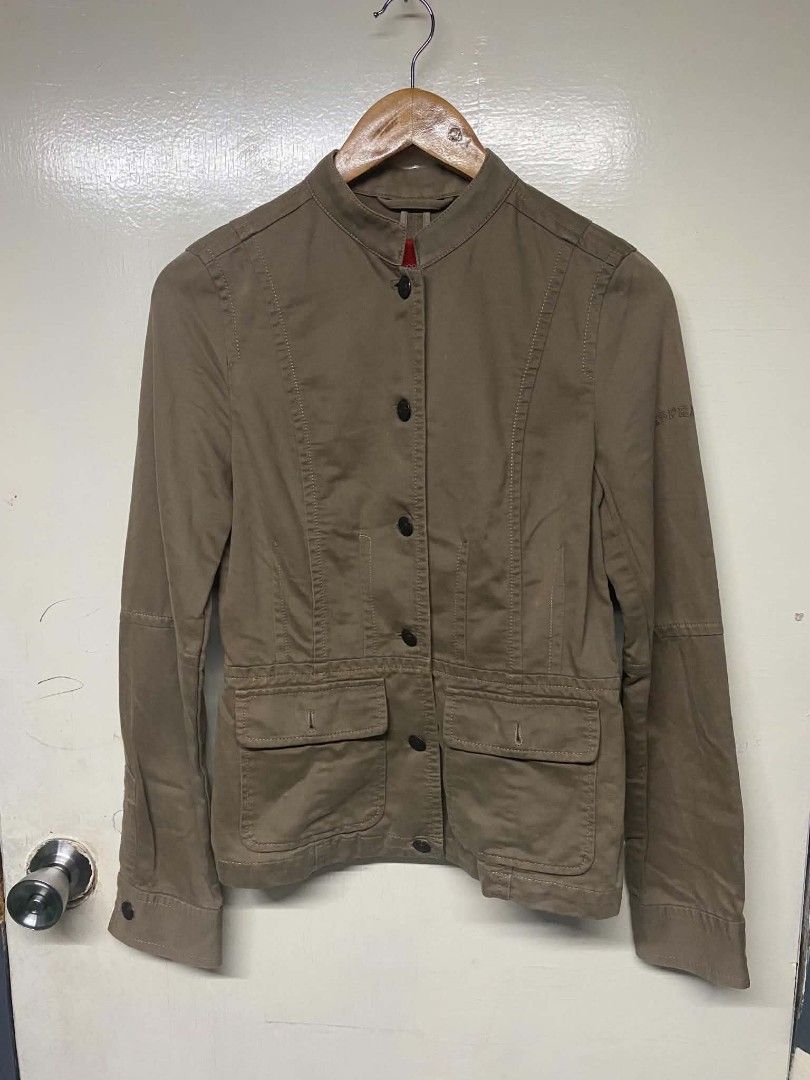 Esprit Brown Cotton Utility Jacket (Category: Coats, Jackets and Outerwear) located in Pasig City. Submitted by jstnisidor81288 (Listing ID 1465761145, Image 1). Description: - Brand: Esprit - Color: Brown - Material: 100% Cotton - Size: Tagged XS - Design: Mandarin collar with front button closure and structured paneled construction - Pockets: Two chest pockets and two lower flap pockets - Details: Embroidered Esprit logo on the left sleeve - Co