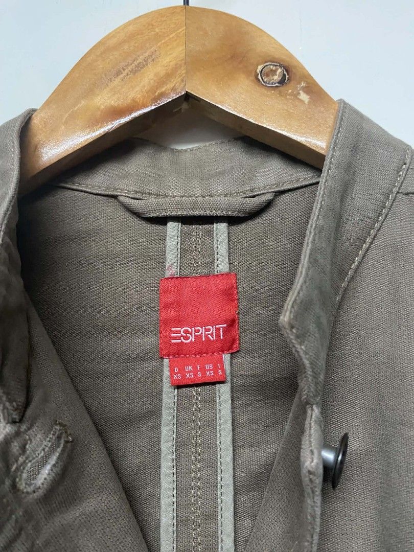 Esprit Brown Cotton Utility Jacket (Category: Coats, Jackets and Outerwear) located in Pasig City. Submitted by jstnisidor81288 (Listing ID 1465761145, Image 2). Description: - Brand: Esprit - Color: Brown - Material: 100% Cotton - Size: Tagged XS - Design: Mandarin collar with front button closure and structured paneled construction - Pockets: Two chest pockets and two lower flap pockets - Details: Embroidered Esprit logo on the left sleeve - Co