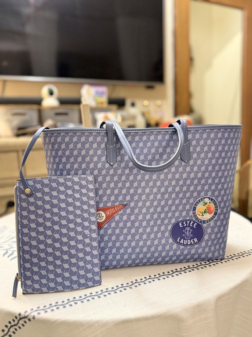 Estée Lauder Tote Bag with Pouch Blue Geometric Pattern (Category: Tote Bags) located in Quezon City. Submitted by cndcvrtc (Listing ID 1465945673, Image 1). Description: - Brand: Estée Lauder promotional set (Tote bag and matching zip pouch) - Design: Stylish blue geometric cube pattern with cute decorative patches (red hotel pennant and citrus fruit) - Features: Double shoulder straps on the tote and a wristlet strap on the pouch - Condition: C