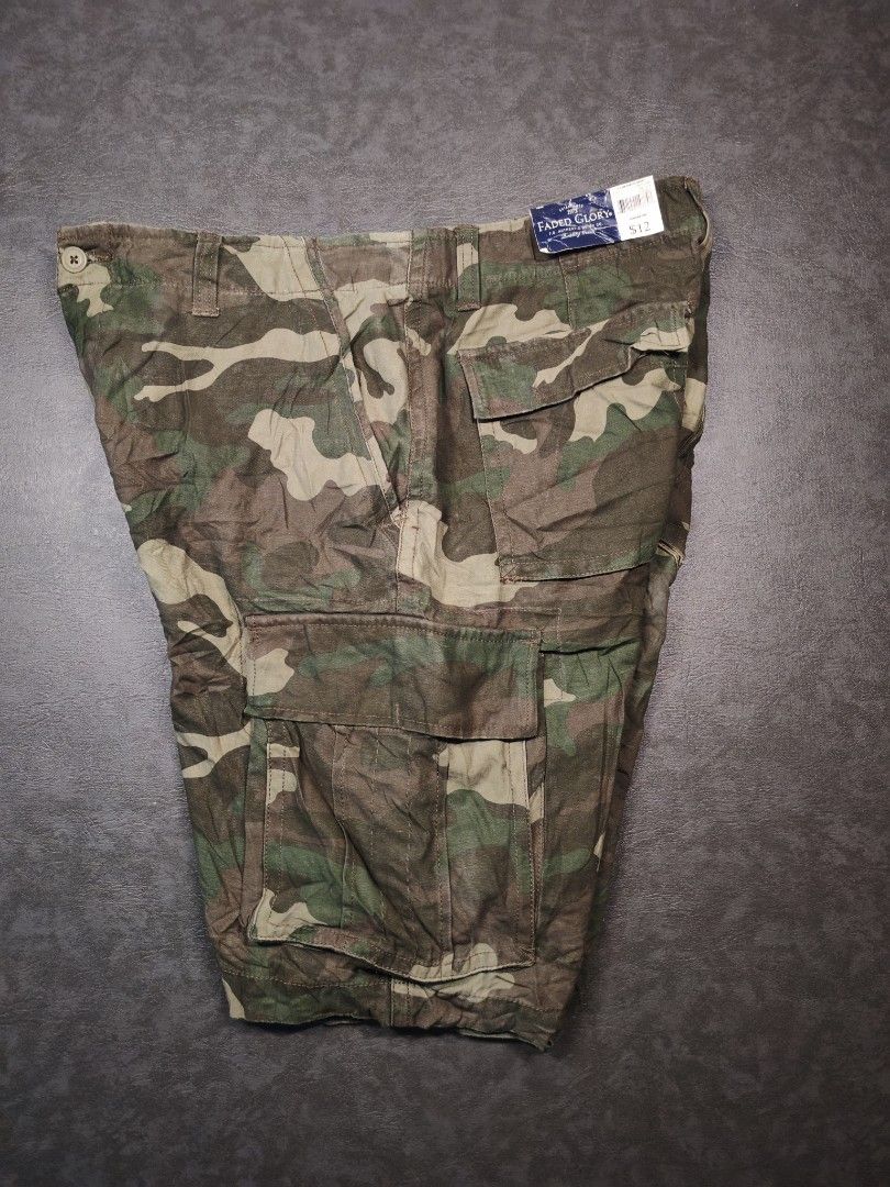 Faded Glory Camo Cargo Shorts (Category: Shorts) located in Kalibo. Submitted by relivethearchives (Listing ID 1465888424, Image 2). Description: Faded Glory Camo Cargo Shorts in Excellent to As New Condition (Hangtag still intact) DIMES Waist: 34 to 36 Length: 32 Hems: 12 📍 Need Wash.