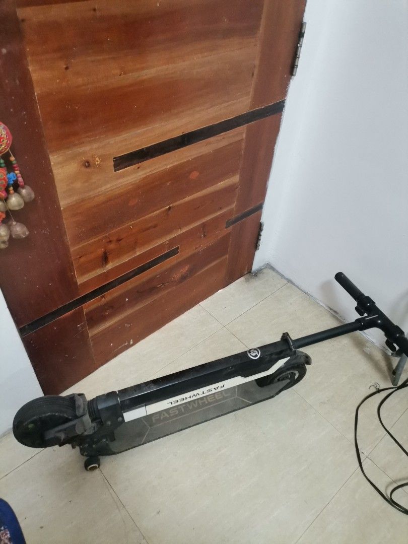 Fastwheel Electric Scooter (Category: Skates, Rollerblades & Scooters) located in Makati City. Submitted by kookybearsstuff (Listing ID 1465801849, Image 1). Description: - Brand: Fastwheel - Color: Black and White - Design: Folds down flat for easy carrying and storage - Condition: Used with some dust and normal wear marks from riding - Features: Power button, indicator lights, and charging port conveniently located near the top handle stem - Wh