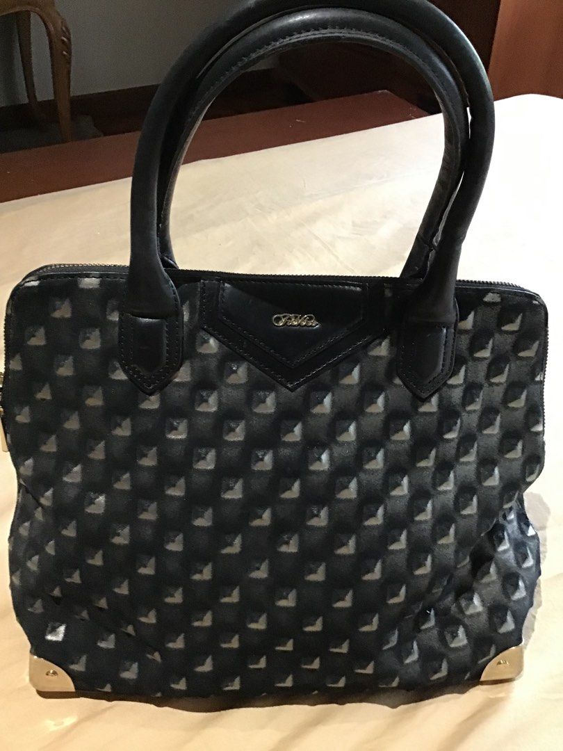 Fiato Lux Black Pyramid Stud Tote Bag (Category: Tote Bags) located in Quezon City. Submitted by rollingstone03 (Listing ID 1465832291, Image 2). Description: - Style: Edgy black tote bag with all-over raised pyramid studs - Hardware: Gold-tone accents on bottom corners and front logo plate - Handles: Comfortable dual rounded leather top handles - Closure & Interior: Secure zip-top closure with neutral beige fabric lining and embossed brand leath