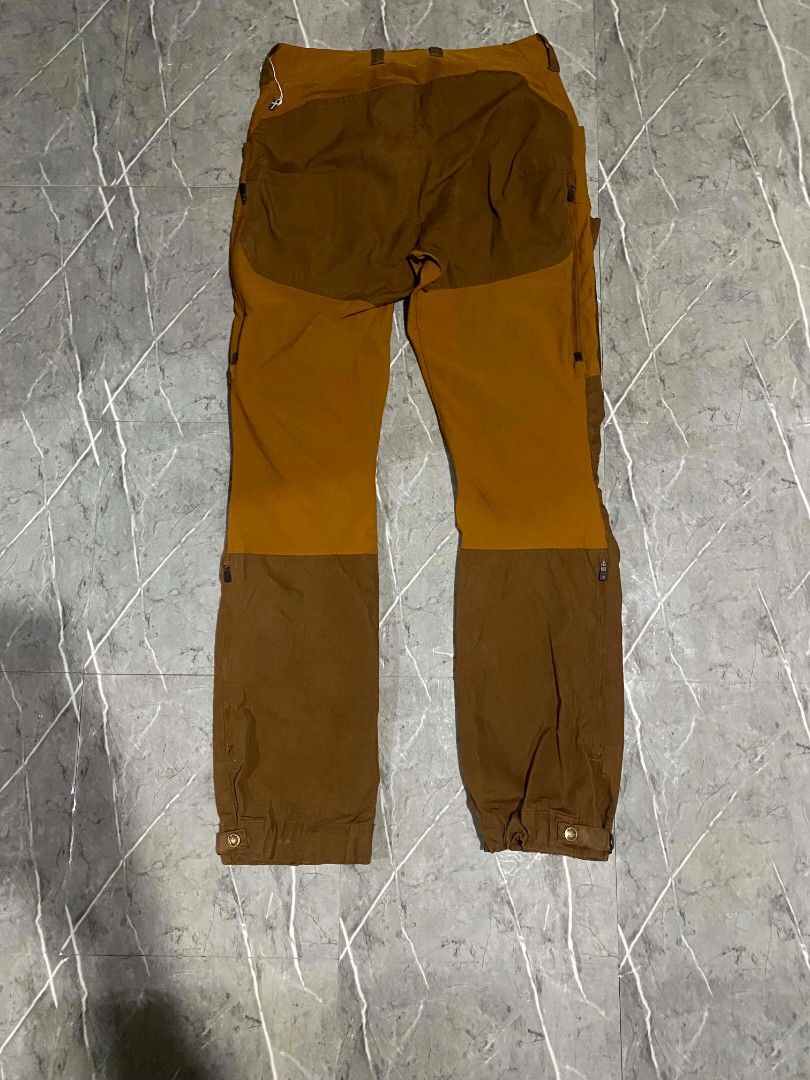 Fjallraven pants (Category: Trousers) located in Polomolok. Submitted by aldrex_18 (Listing ID 1465888146, Image 3). Description: - Brand: Fjallraven - Colorway: Ochre and Autumn Leaf Brown - Material: G-1000 Eco on reinforcement zone - Origin: Made in Vietnam - Features: Ventilation zippers along thighs and calves, adjustable straps at leg endings - Condition: Premium outdoor technical trekking pants size 30.