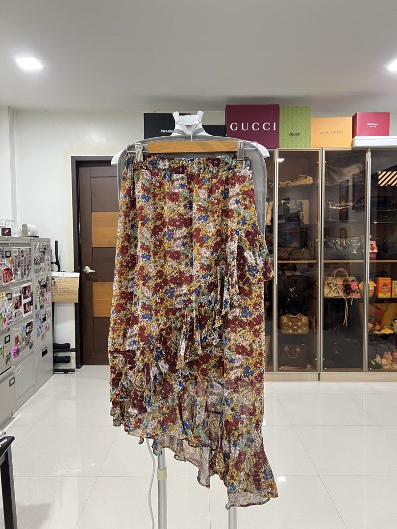 Floral Print Ruffle High Low Skirt (Category: Skirts) located in Manila. Submitted by imprincessg888 (Listing ID 1465856450, Image 1). Description: - Vibrant multicolor floral print on a mustard yellow base - Lightweight and flowy chiffon fabric - Stylish asymmetric high-low hem with ruffle detailing - Comfortable elastic waistband for an easy fit - Ideal for warm weather, vacations, and casual outings.