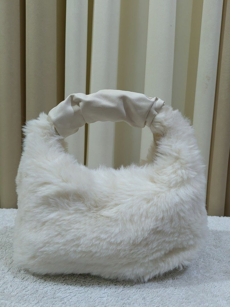 Fluffy white plush Pouch (Category: Purses & Pouches) located in Makati City. Submitted by prelovedtreatedwithlove (Listing ID 1465768362, Image 3). Description: - Super soft and fluffy white faux fur - Adorable pink rabbit ears detail and matching pink inner lining - Secure top magnetic snap closure - Perfect cute accessory for casual days or make up organizer for travel -Free na ung fur handbag - just need wash. -A-218.