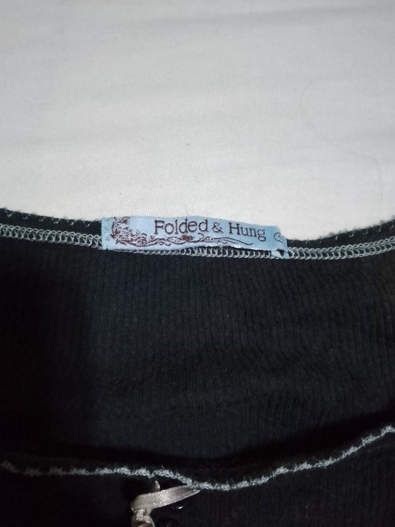 Folded & Hung Black Ribbed Short Sleeve Top (Category: Shirts) located in Batangas. Submitted by sheenx.09 (Listing ID 1465793535, Image 2). Description: - Brand: Folded & Hung - S on tag ( S to M) - Color: Black - Style: Fitted short sleeve ribbed top ♥️ - Neckline: Scoop neck with contrast stitching and mini decorative buttons 😁 - Accents: Cute front ribbon and embroidered logo initials near the bottom hem 😀 - Perfect for casual days, school,
