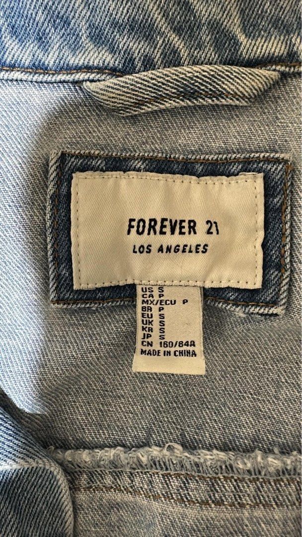 Forever 21 Denim Jacket Size S (Category: Coats, Jackets and Outerwear) located in Manila. Submitted by longbondpaper (Listing ID 1465875247, Image 2). Description: - Brand: Forever 21 Los Angeles - Size: S (fits US, CA, UK, JP) - Color/Wash: Classic light blue denim - Design: Standard collar with button-up front - Fit: Standard fit, highly versatile and easy to match .