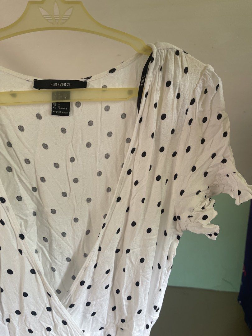 Forever 21 White Polka Dot Wrap Dress (Category: Dresses) located in Baybay. Submitted by shikita27906 (Listing ID 1465841525, Image 2). Description: - Brand: Forever 21 - Style: Midi wrap dress with V-neckline and side tie waist - Pattern: White with classic black polka dots - Details: Short sleeves with cute ruffled cuffs - Fabric: Lightweight and breathable - Size: S (tag still attached).
