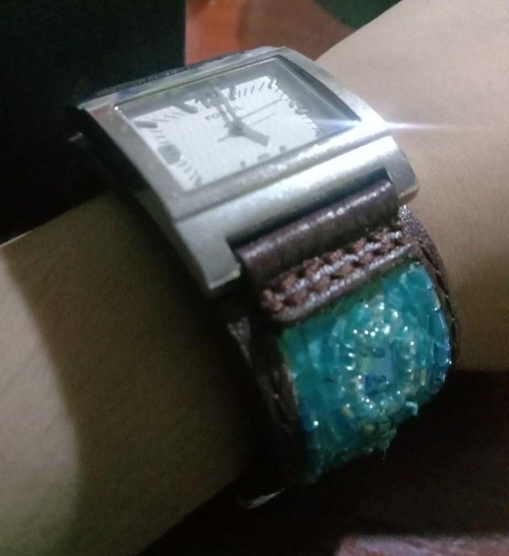 Fossil JR8832 quartz (Category: Women's Watches) located in Santa Rosa. Submitted by Sofia_Paprika (Listing ID 1465882763, Image 2). Description: - Brand: Fossil - Dial: Square white textured dial with silver numbers - Case: Silver-tone stainless steel - Strap: Brown leather cuff with intricate blue and turquoise glass beads - Inclusions: Original storage box included - Condition: Excellent, unique statement piece.