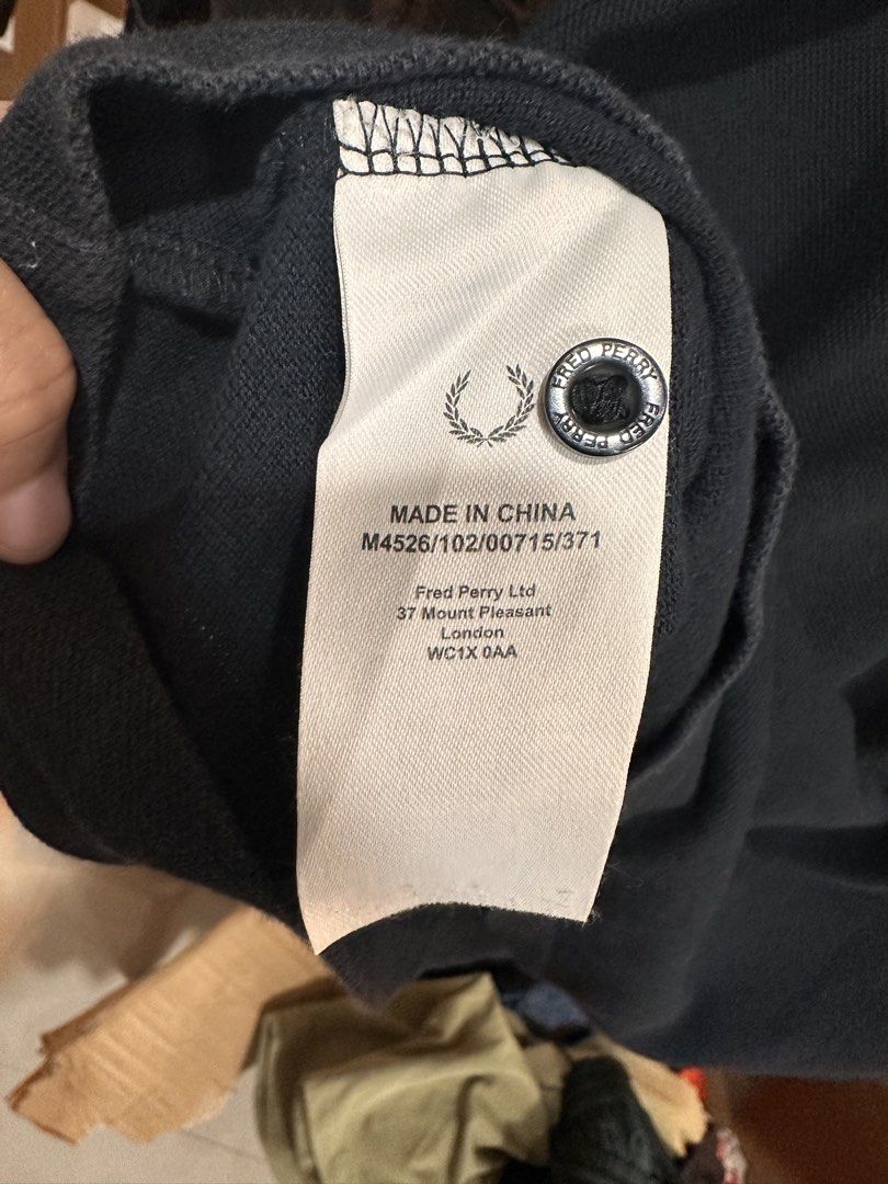 Fred Perry Polo Shirt (Category: Tshirts & Polo Shirts ) located in Bulacan. Submitted by adoseofluxxee (Listing ID 1465763109, Image 3). Description: - Brand: Fred Perry - Color: Dark Navy Blue - Size: L - Material: 100% Cotton (Made in China) - Design: Ribbed collar with striped tipping, two-button placket, and signature embroidered laurel wreath logo on the chest - Condition: Excellent casual wear staple.