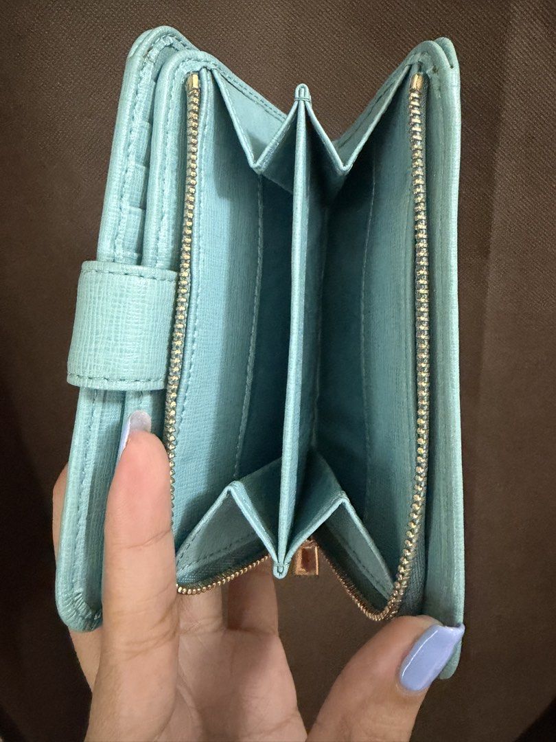 Furla Wallet (Category: Wallets & Card holders) located in Pateros City. Submitted by nightingayle29 (Listing ID 1465768235, Image 2). Description: - Brand: Furla - Color: Light blue with elegant gold hardware - Material: Durable Saffiano leather texture - Closure: Secure snap and smooth zip-around action - Interior: Divided compartments and multiple card slots - Condition: like new - Size: Medium - no inclusion.