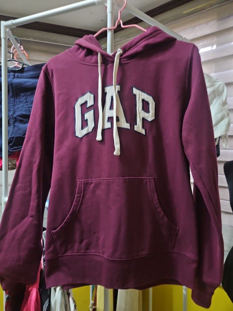 GAP Maroon Hoodie with Front Pocket (Category: Coats, Jackets and Outerwear) located in Calamba. Submitted by handpickedbynetty (Listing ID 1465831285, Image 1). Description: - Authentic GAP hoodie in a rich maroon color - Large white appliqued GAP logo on the chest - Adjustable drawstring hood with white cords - Classic front kangaroo pocket - Ribbed cuffs and hem for a snug fit - Soft and cozy cotton blend material - Ideal for casual, everyday 