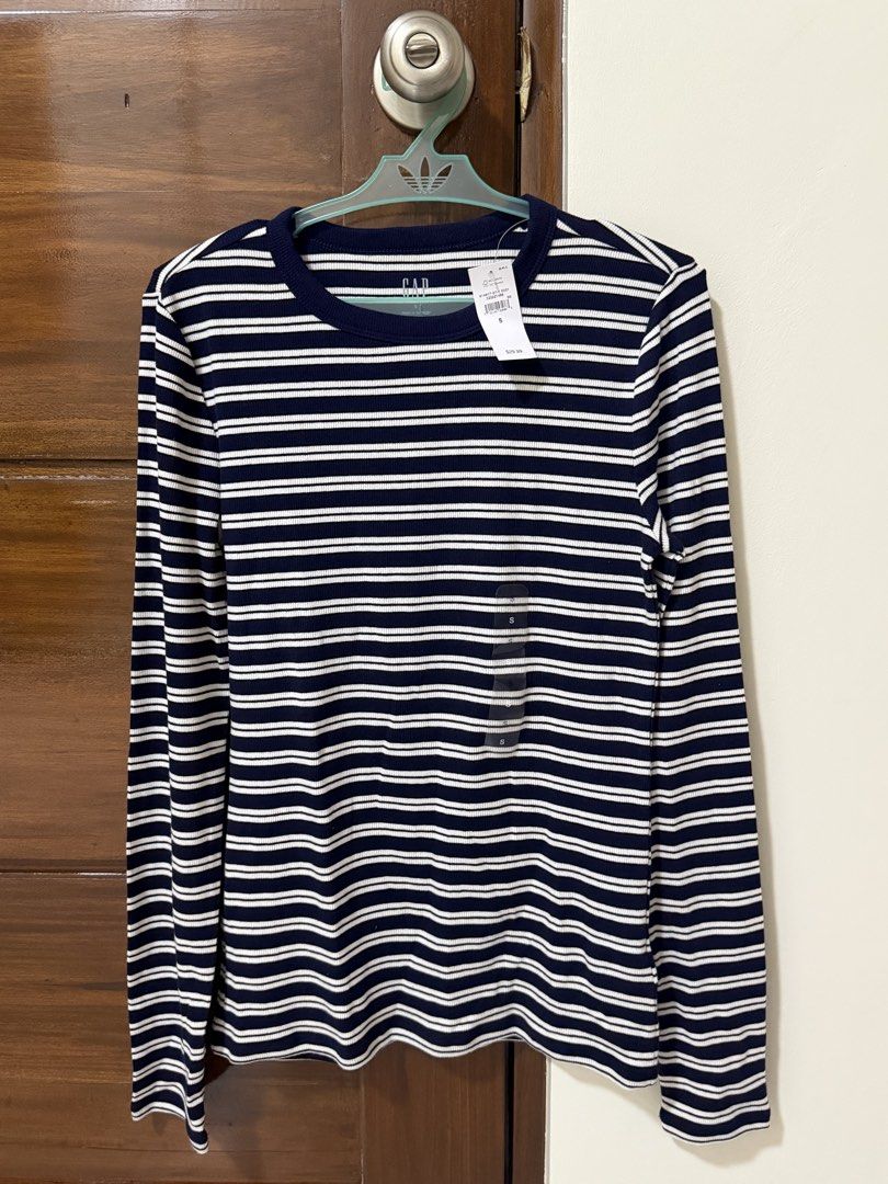 GAP Navy Striped Long Sleeve Top Size S (Category: Longsleeves) located in Quezon City. Submitted by wishmejuu (Listing ID 1465866865, Image 1). Description: - Brand: GAP - Style: Long sleeve top with classic navy and white stripes - Details: Crew neckline, ribbed fabric texture, regular fit - Size: Small - Condition: Brand New with Tags (BNWT), never worn - Perfect for: Everyday casual wear or easy layering.