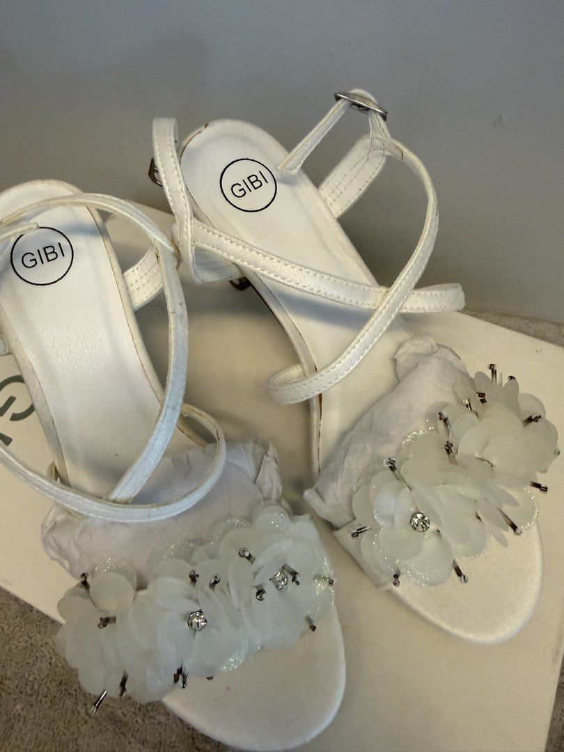 Gibi Medea White Floral Heels Size 35 (Category: Heels) located in Santa Rosa. Submitted by alyssa21 (Listing ID 1465953661, Image 1). Description: - Brand: Gibi Medea - Style: Strappy heels with floral & rhinestone toe strap - Color: White - Size: 35 - Condition:used only in pictorial - Inclusions: Original box with tag - Original Price: ₱2,299.75.