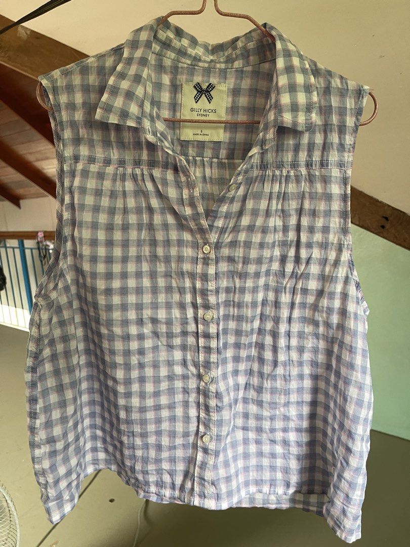 Gilly Hicks Sydney Blue White Gingham Sleeveless Button Up (Category: Sleeveless) located in Baybay. Submitted by shikita27906 (Listing ID 1465848779, Image 1). Description: - Brand: Gilly Hicks Sydney - Size: S - Design: Blue and white gingham with subtle pink grid lines - Style: Sleeveless, classic collar, front button closure - Material: Lightweight cotton - Condition: Great warm weather staple.