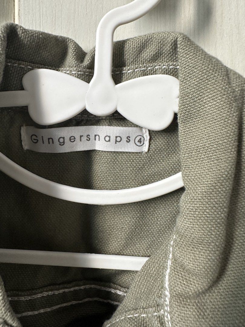 Gingersnaps Green Cropped Jacket Size 4 (Category: Babies & Kids Fashion) located in Quezon City. Submitted by maricrisdiokno (Listing ID 1465828199, Image 2). Description: - Brand: Gingersnaps - Size: 4 - Color: Green with white contrast stitching - Material: Sturdy cotton fabric - Features: Button-up front, collar, and chest pockets - Back Details: Cute embroidered parrot graphic and pink text accent - Condition: Great statement piece for kids.