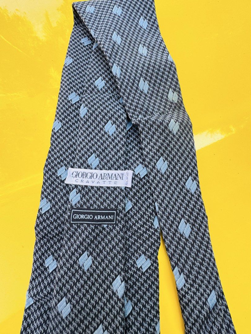 Giorgio Armani Cravatte Silk Tie Blue Grey Pattern (Category: Ties) located in Santa Cruz. Submitted by maqui15 (Listing ID 1465952183, Image 3). Description: - Brand: Giorgio Armani Cravatte - Material: 100% Premium Silk - Color/Pattern: Dark blue base with textured detailing and light blue square accents - Design: Classic width with signature branded lining inside the tail - Origin: Crafted in Italy - Condition: Ready to wear, excellent for for