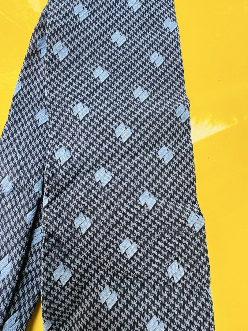 Giorgio Armani Cravatte Silk Tie Blue Grey Pattern (Category: Ties) located in Santa Cruz. Submitted by maqui15 (Listing ID 1465952183, Image 2). Description: - Brand: Giorgio Armani Cravatte - Material: 100% Premium Silk - Color/Pattern: Dark blue base with textured detailing and light blue square accents - Design: Classic width with signature branded lining inside the tail - Origin: Crafted in Italy - Condition: Ready to wear, excellent for for