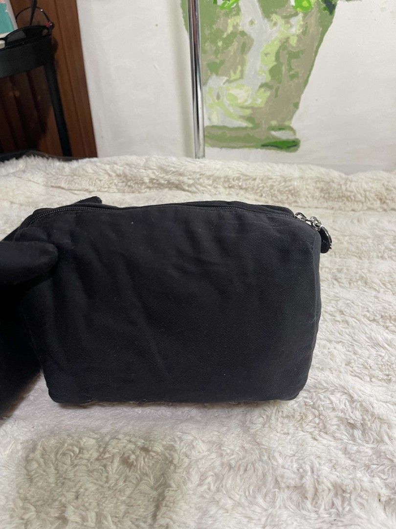 Givenchy Parfums Black Canvas Toiletry Makeup Pouch Bag (Category: Luxury Bags & Wallets) located in Naawan. Submitted by twilly.apparel2 (Listing ID 1465840665, Image 3). Description: - Brand: Givenchy Parfums - Material: Durable black canvas with smooth branded inner lining - Design: Embroidered logo patch on the front with a stylish circular silver zipper pull - Storage: Main zipper compartment plus a convenient inner zipper pocket - Use: Hand