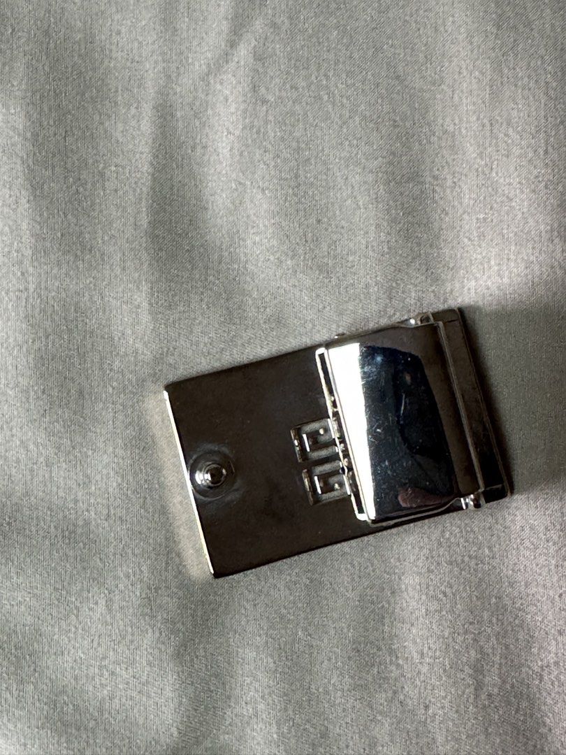 Givenchy Silver Belt Buckle (Category: Belts) located in Manila. Submitted by seangoart (Listing ID 1465793437, Image 3). Description: - Authentic Givenchy silver-tone belt buckle - Iconic 4G logo cut-out design on the front - Made in Italy stamp on the hinge mechanism - Standard pin fastening on the back - Solid weight with a polished finish - Condition: Shows minor signs of wear and handling marks.