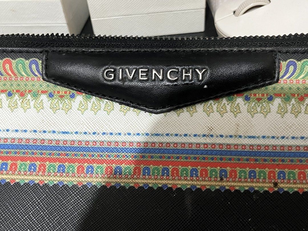RUSH RUSH RUSH!! Givenchy zip pouch/clutch or document-style bag (Category: Purses & Pouches) located in Taguig. Submitted by mailipang758544 (Listing ID 1465854295, Image 1). Description: Givenchy zip pouch/clutch or document-style bag The important thing is the condition: there is noticeable wear, especially the peeling/chipping at the corners, discoloration/staining on the fabric, and general signs of age. The zipper and Givenchy plaque still 