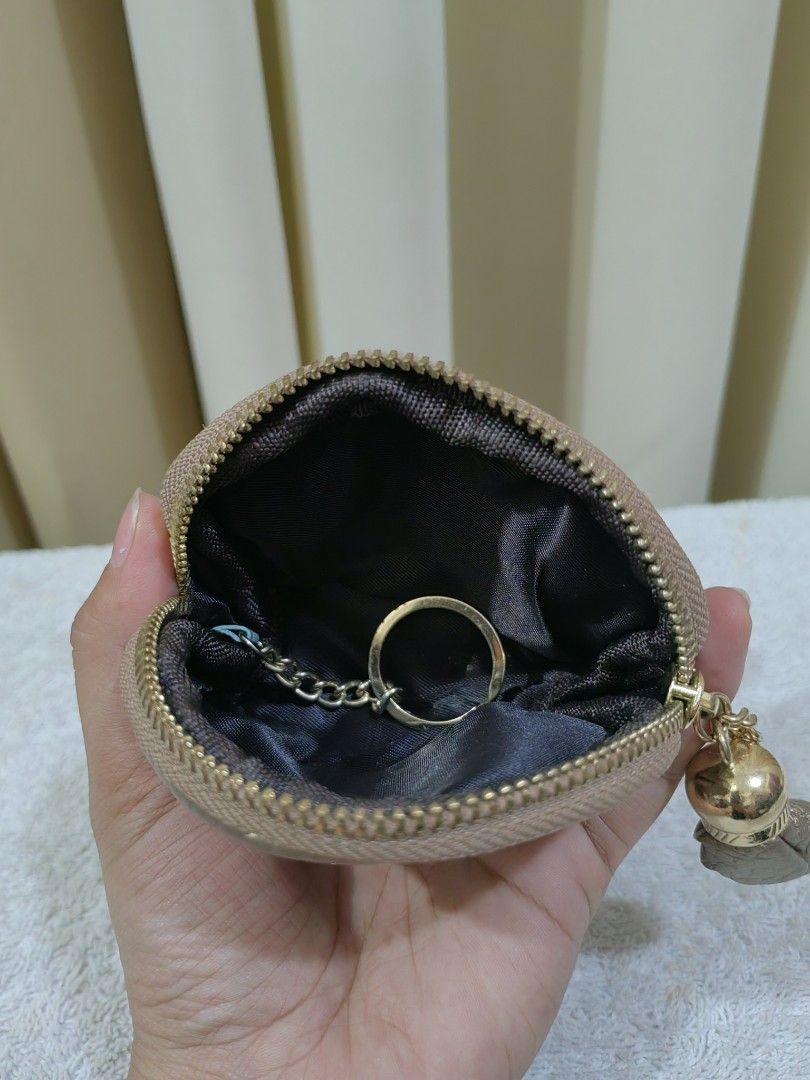Gold coin purse (Category: Purses & Pouches) located in Makati City. Submitted by prelovedtreatedwithlove (Listing ID 1465782395, Image 3). Description: - Eye-catching gold metallic coin purse with a textured finish and adorable bee emblem - Secure zipper closure adorned with a stylish gold-tone tassel and tiny heart padlock charm - Clean fabric-lined interior complete with an attached key ring on a small chain - Compact and versatile: ideal for 