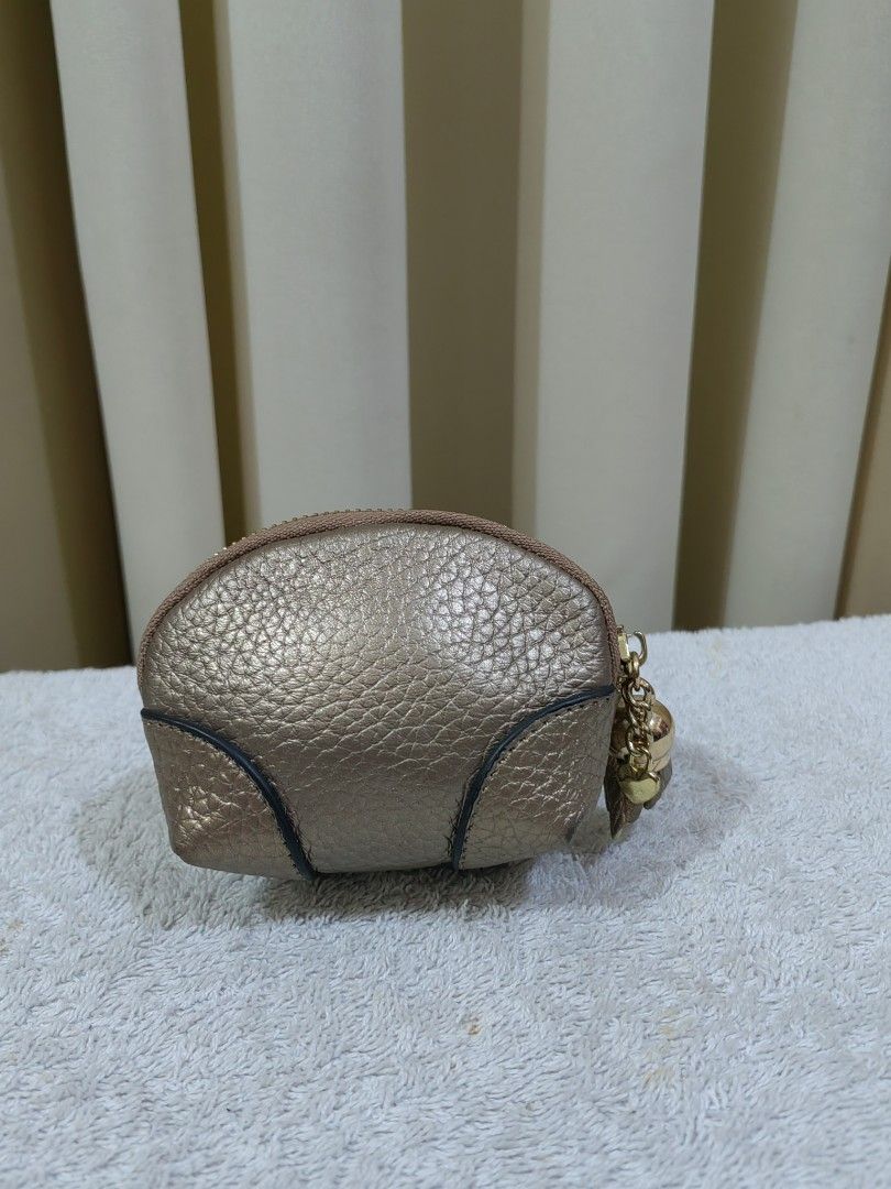 Gold coin purse (Category: Purses & Pouches) located in Makati City. Submitted by prelovedtreatedwithlove (Listing ID 1465782395, Image 2). Description: - Eye-catching gold metallic coin purse with a textured finish and adorable bee emblem - Secure zipper closure adorned with a stylish gold-tone tassel and tiny heart padlock charm - Clean fabric-lined interior complete with an attached key ring on a small chain - Compact and versatile: ideal for 