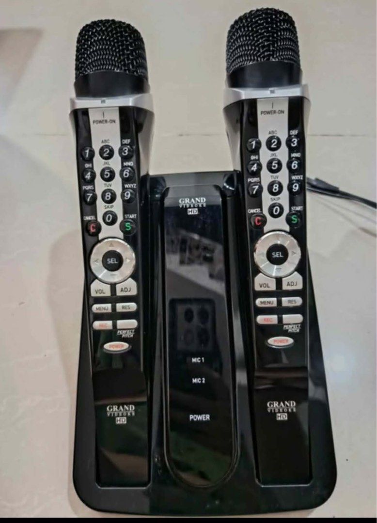 Grand videoke symphony SE Pro plus (Category: Microphones) located in Cavite. Submitted by ai__chang (Listing ID 1465934375, Image 1). Description: - Brand: Grand Videoke - Model: Symphony SE Pro Plus - Color: Black and Silver - Inclusions: 2 wireless microphones, base station, remote control, and official song list book - Features built-in keypad controls on microphones for easy song searching - Ideal for home use, parties, and family gatherings