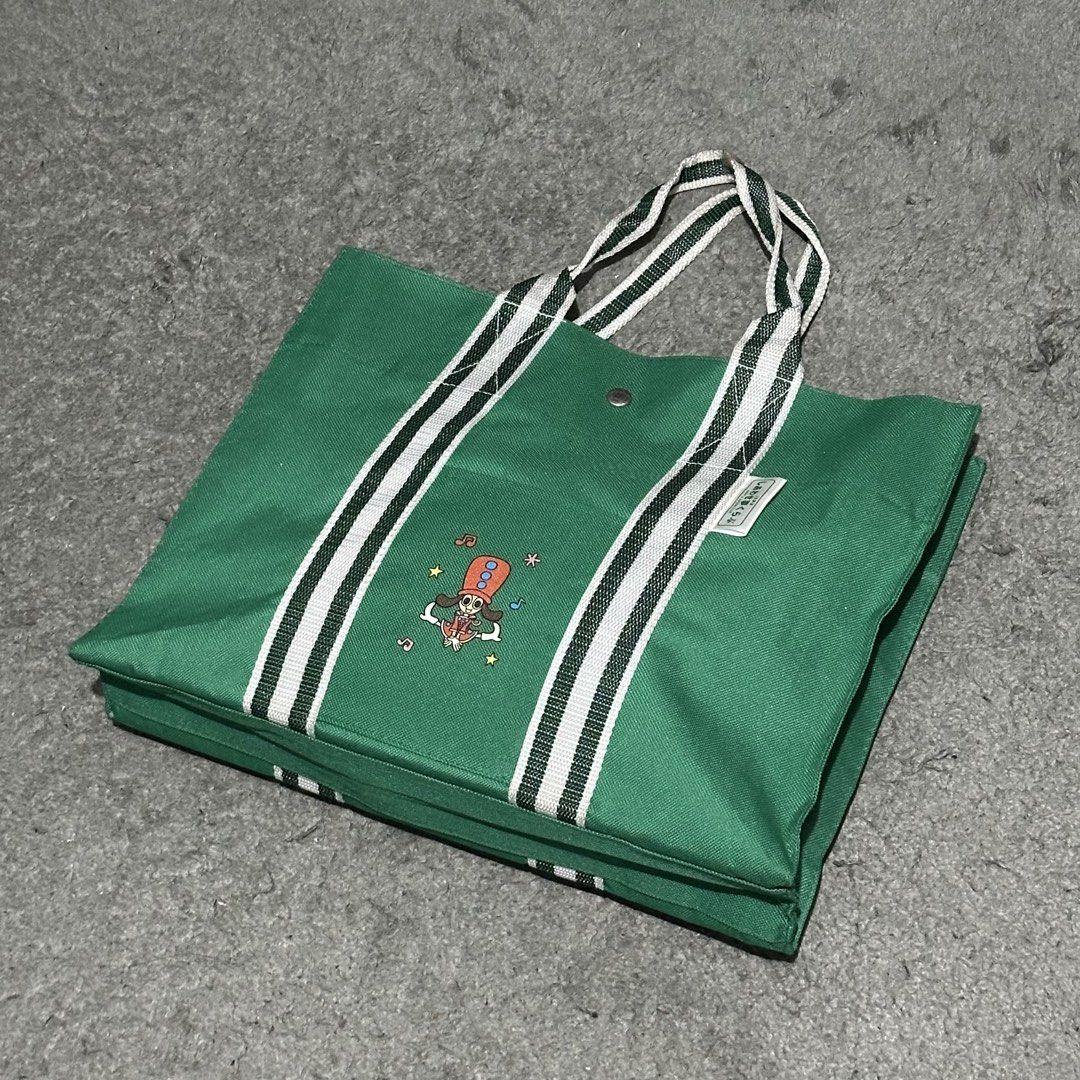 Green Canvas Tote Bag with Brook Graphic (Category: Tote Bags) located in Lipa City. Submitted by jecoparra (Listing ID 1465842617, Image 2). Description: - Green canvas tote bag with One Piece Brook graphic - Secure top snap button closure - Durable green and white double-striped handles - Structured rectangular bottom for better support - Clean fabric, ideal for books and daily essentials.