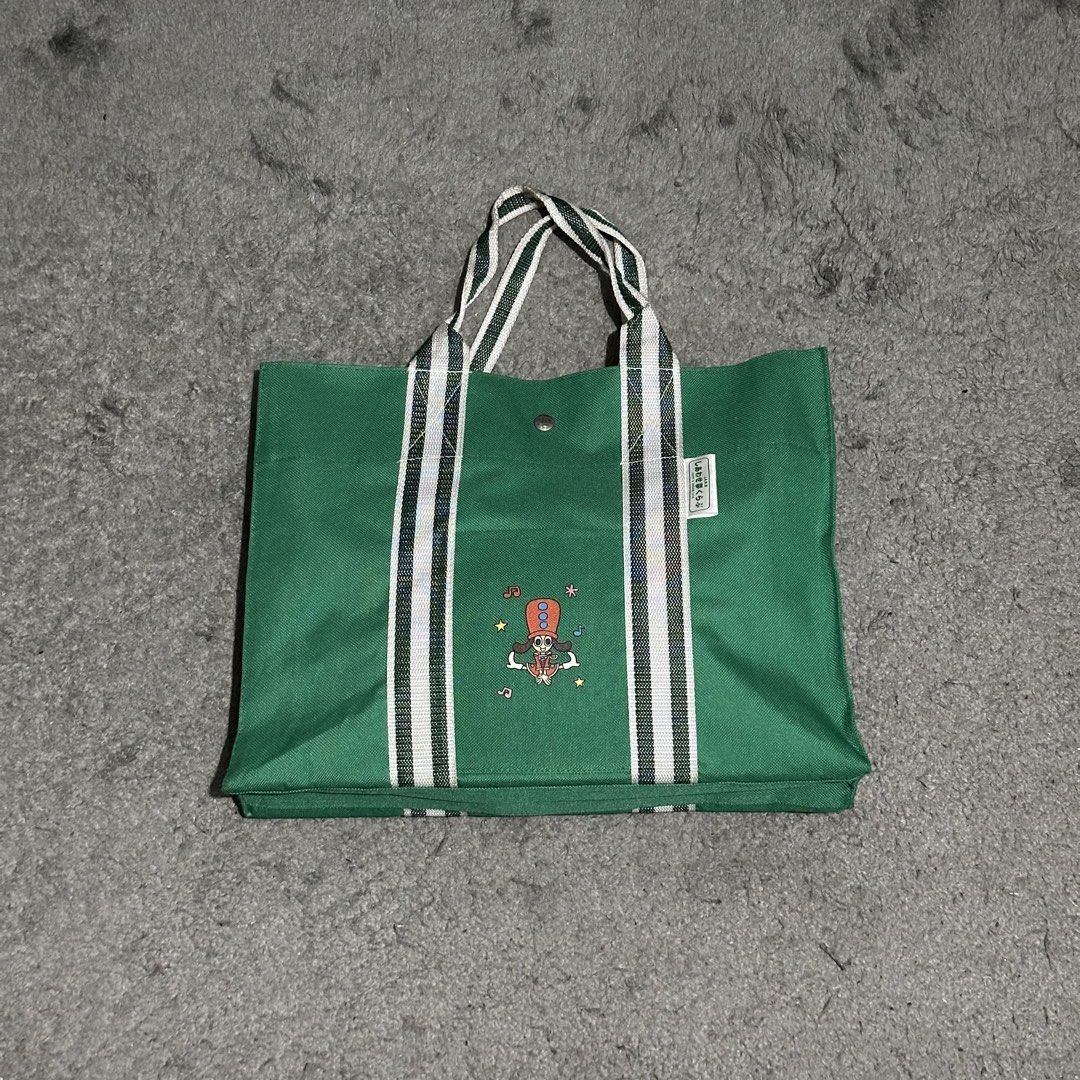 Green Canvas Tote Bag with Brook Graphic (Category: Tote Bags) located in Lipa City. Submitted by jecoparra (Listing ID 1465842617, Image 1). Description: - Green canvas tote bag with One Piece Brook graphic - Secure top snap button closure - Durable green and white double-striped handles - Structured rectangular bottom for better support - Clean fabric, ideal for books and daily essentials.