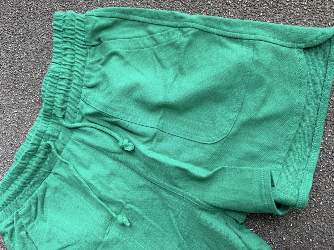 Green Cotton Casual Shorts with Drawstring (Category: Shorts) located in San Fernando. Submitted by houseof_jj (Listing ID 1465781400, Image 3). Description: USED - Size: S - Color: Bright green - Material: Soft textured cotton - Features: Elastic waistband with matching adjustable drawstring, two front patch pockets, and a stylish curved hem - Condition: Neat stitching throughout, perfect for casual everyday wear.