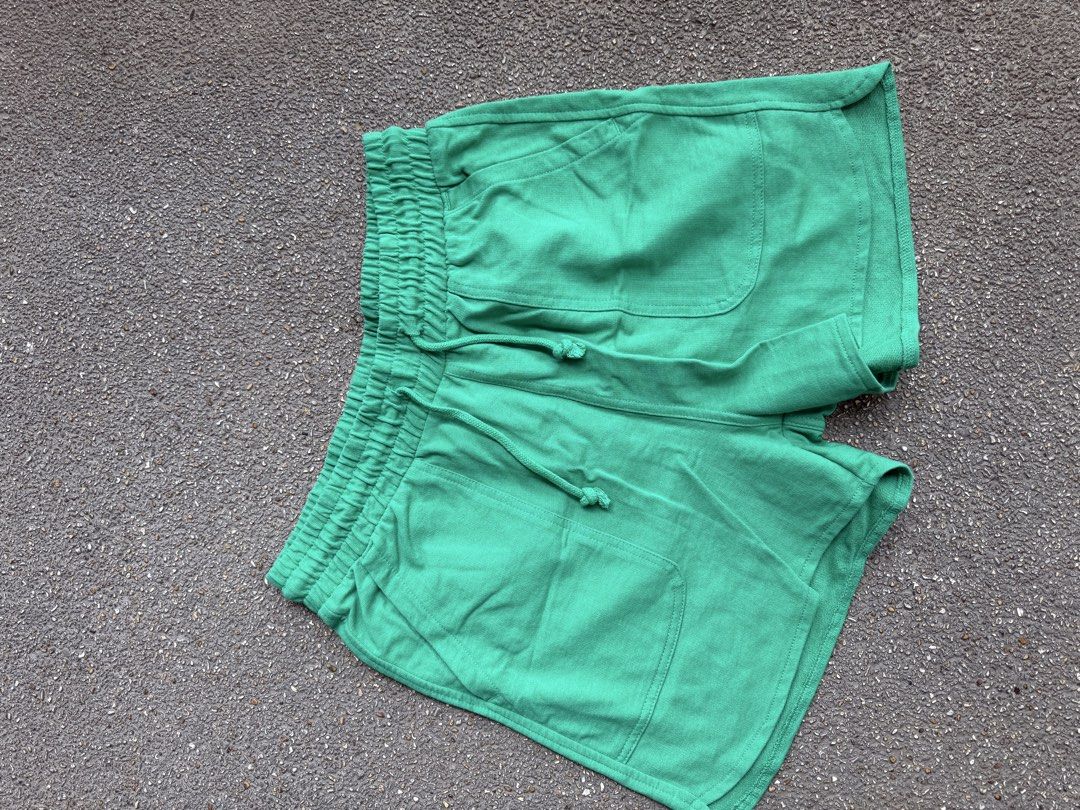 Green Cotton Casual Shorts with Drawstring (Category: Shorts) located in San Fernando. Submitted by houseof_jj (Listing ID 1465781400, Image 2). Description: USED - Size: S - Color: Bright green - Material: Soft textured cotton - Features: Elastic waistband with matching adjustable drawstring, two front patch pockets, and a stylish curved hem - Condition: Neat stitching throughout, perfect for casual everyday wear.
