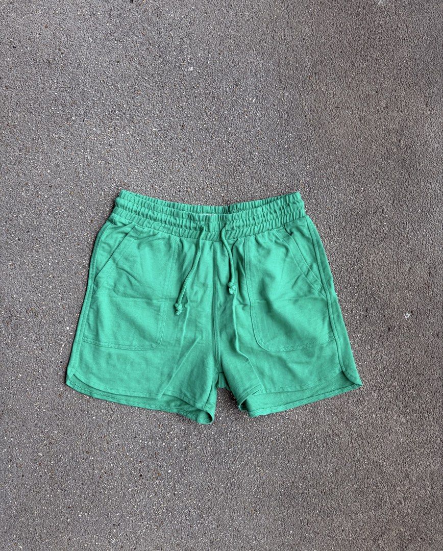 Green Cotton Casual Shorts with Drawstring (Category: Shorts) located in San Fernando. Submitted by houseof_jj (Listing ID 1465781400, Image 1). Description: USED - Size: S - Color: Bright green - Material: Soft textured cotton - Features: Elastic waistband with matching adjustable drawstring, two front patch pockets, and a stylish curved hem - Condition: Neat stitching throughout, perfect for casual everyday wear.