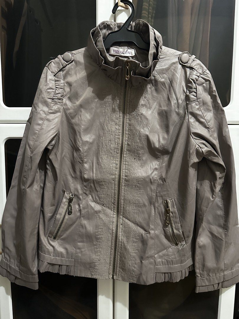 Grey Faux Leather Zip Jacket (Category: Coats, Jackets and Outerwear) located in Quezon City. Submitted by chewich (Listing ID 1465881688, Image 1). Description: - Color: Grey - Material: Premium faux leather with clean interior lining - Design: High ruffled collar, full front zip, and dual side zipper pockets - Details: Textured center front panel, pleated shoulders, and pleated hemline - Fit: Structured fit with long sleeves - Condition: Excell