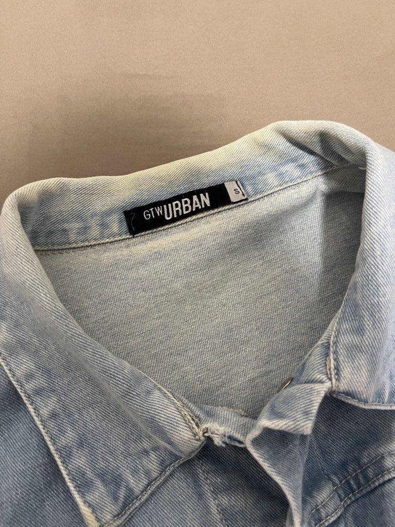 Cropped Denim Jacket Size S (Category: Coats, Jackets and Outerwear) located in Marikina City. Submitted by maicsg_ (Listing ID 1465769305, Image 3). Description: - Brand/Model: GTW Urban denim jacket - Color/Wash: Light wash - Size: Small - Fit/Style: Cropped length with raw frayed hem and classic collar - Details: Button-up front, chest pockets, buttoned cuffs - Graphic: Back features 'It's hard to be humble' quote and a pink heart graphic - Co