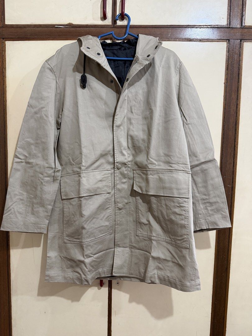 GU Beige Hooded Long Coat Jacket with Pockets Medium (Category: Coats, Jackets and Outerwear) located in Manila. Submitted by preloved_new_forsale (Listing ID 1465920304, Image 1). Description: - Color: Beige with contrasting black inner lining - Closure: Front zipper and button closure - Pockets: Two large front flap pockets for ample storage - Length: Long sleeves and extended hem hitting past the hips - Condition: Clean fabric with visible fol