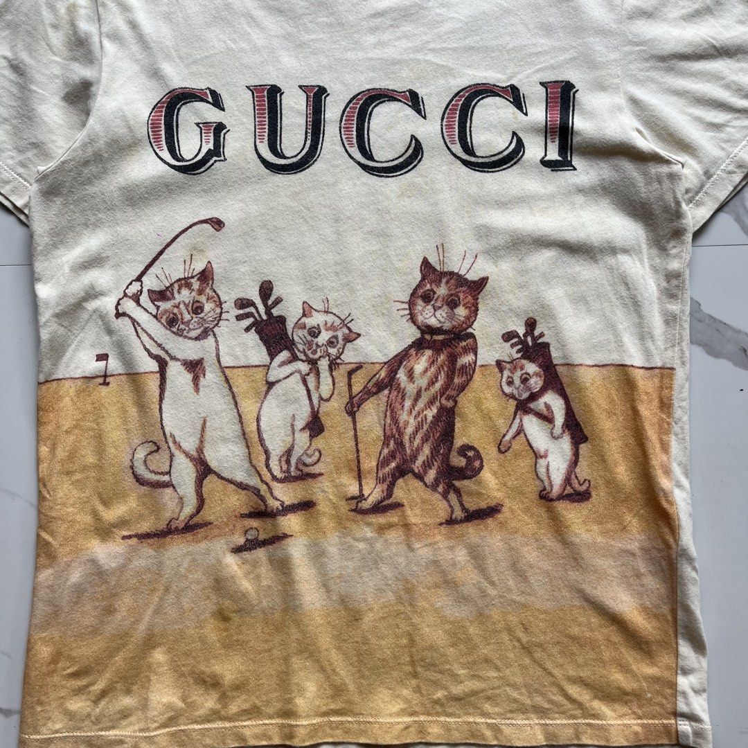 Gucci (Category: Luxury Apparel) located in Lucena. Submitted by RAGGGGSSSS (Listing ID 1465892967, Image 3). Description: Gucci Neutral Cat Playing Golf Size 12 on Tag Fits womens Small 22x16 Verygood Condition Authentic Need minor wash only 900 .