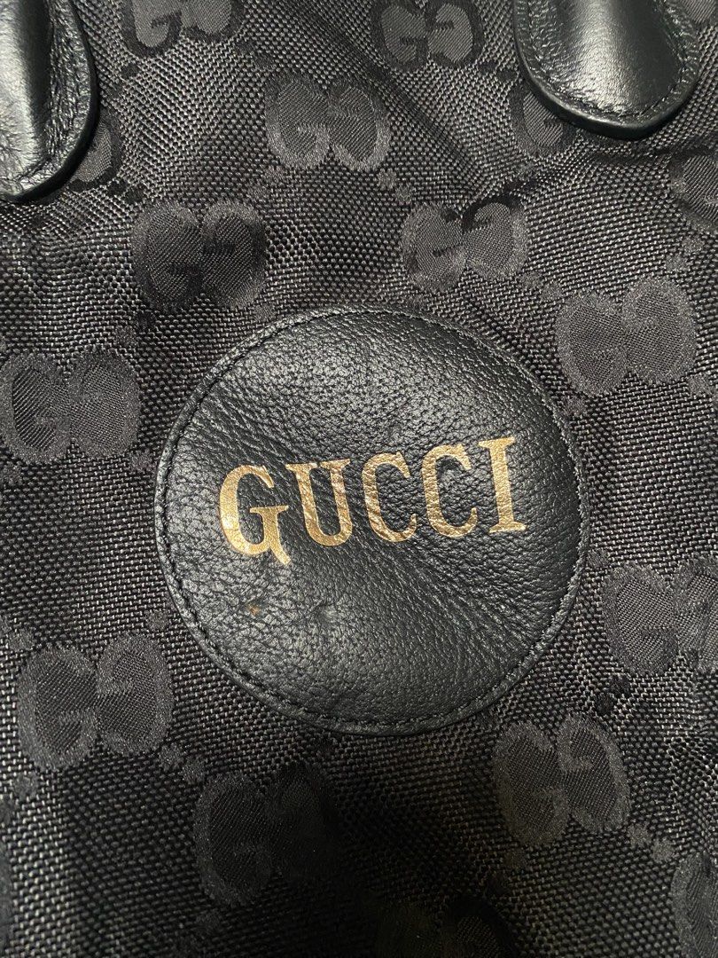 Gucci Black Monogram Canvas Tote Bag (Category: Luxury Bags & Wallets) located in Manila. Submitted by ukayganda08 (Listing ID 1465875423, Image 2). Description: - Brand: Gucci - Style: Tote bag with iconic monogram canvas pattern - Color: Black with gold hardware - Material: Monogram canvas with premium leather handles - Features: Circular front logo patch with gold lettering, spacious interior, fabric lining, and zippered side pockets - Extras:
