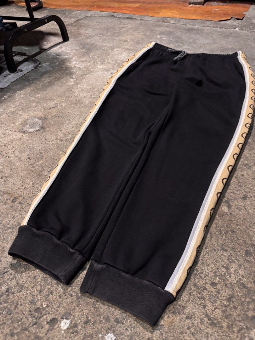Gucci Black Sweatpants with Interlocking G Side Stripes (Category: Joggers) located in Pasig City. Submitted by dripthrift1600 (Listing ID 1465949464, Image 3). Description: - Authentic Gucci sweatpants in classic black fleece - Elastic waistband with adjustable drawstring closure - Signature tan side stripes with iconic interlocking G monogram and white piping - Comfortable cuffed ankles and casual fit - Premium clean cotton blend material - Mad