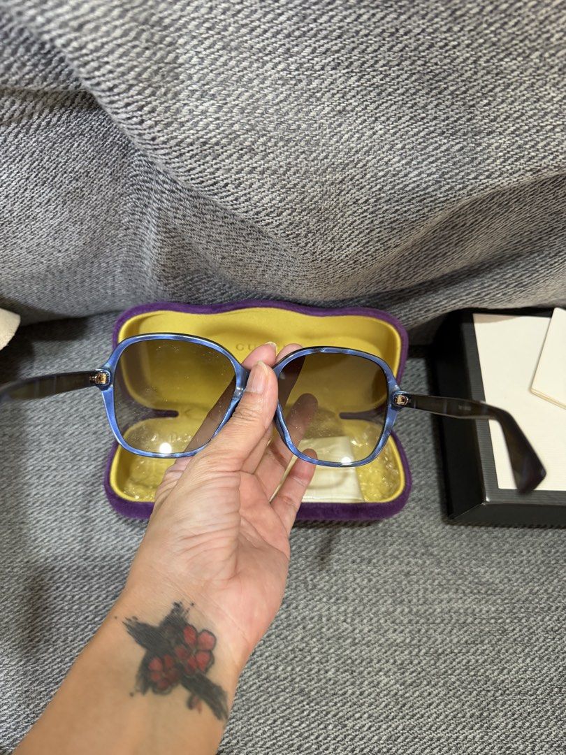Gucci Blue Square Sunglasses with Case (Category: Sunglasses & Eyewear) located in Las Pinas. Submitted by wackywel (Listing ID 1465770516, Image 3). Description: - Brand: Gucci - Frame Color: Blue - Lenses: Gradient brown - Details: Signature interlocking G logo on temples and bee detail near the tips - Condition: Great everyday shades - Inclusions: Purple velvet hard case with yellow interior, cleaning cloth, and original box.
