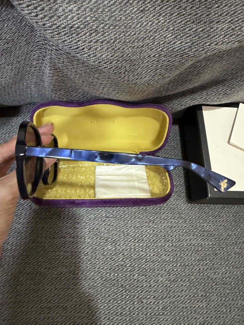 Gucci Blue Square Sunglasses with Case (Category: Sunglasses & Eyewear) located in Las Pinas. Submitted by wackywel (Listing ID 1465770516, Image 2). Description: - Brand: Gucci - Frame Color: Blue - Lenses: Gradient brown - Details: Signature interlocking G logo on temples and bee detail near the tips - Condition: Great everyday shades - Inclusions: Purple velvet hard case with yellow interior, cleaning cloth, and original box.
