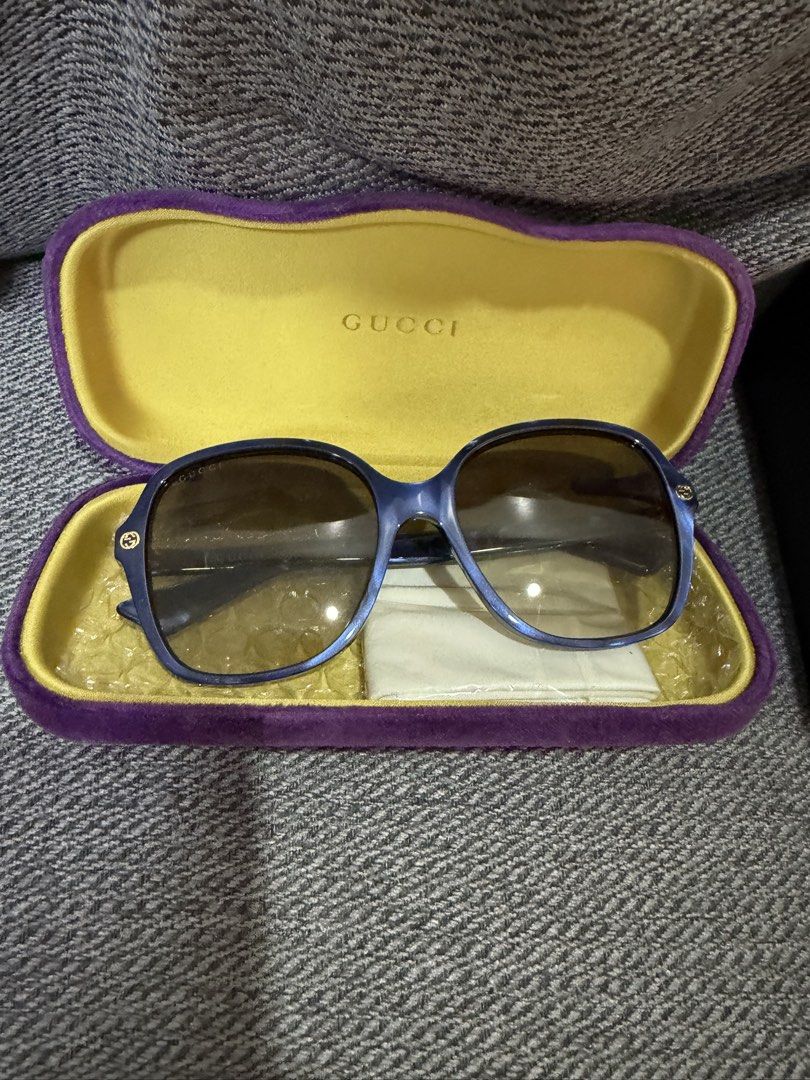 Gucci Blue Square Sunglasses with Case (Category: Sunglasses & Eyewear) located in Las Pinas. Submitted by wackywel (Listing ID 1465770516, Image 1). Description: - Brand: Gucci - Frame Color: Blue - Lenses: Gradient brown - Details: Signature interlocking G logo on temples and bee detail near the tips - Condition: Great everyday shades - Inclusions: Purple velvet hard case with yellow interior, cleaning cloth, and original box.