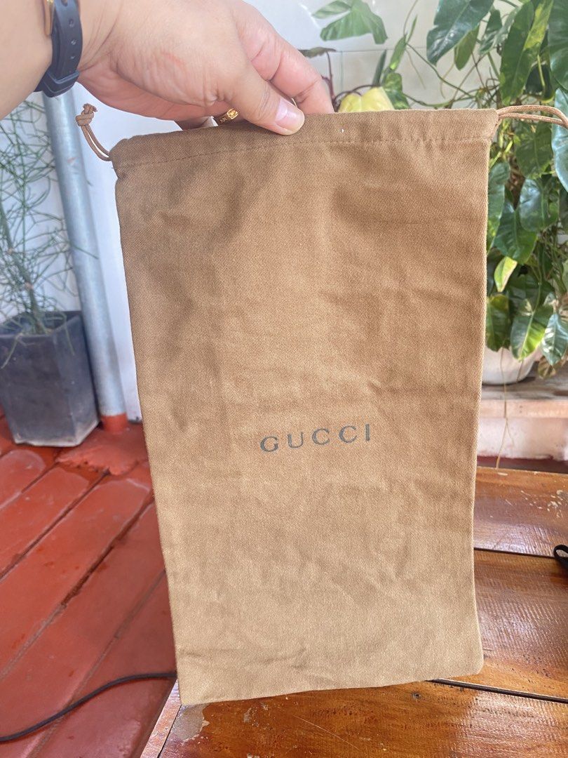 Gucci Brown Dust Bag (Category: Luxury Bags & Wallets) located in San Fernando. Submitted by jecscollectionsshoppee (Listing ID 1465841669, Image 1). Description: - Authentic Gucci dust bag - Color: Brown cotton fabric - Closure: Drawstring top - Details: Classic Gucci logo stamped on the front - Condition: Clean interior and exterior - Size: Standard medium, ideal for luxury bags or accessories.