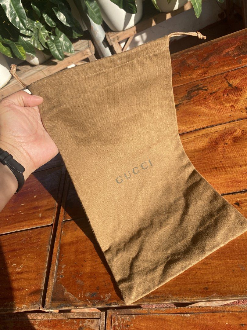 Gucci Brown Dust Bag (Category: Luxury Bags & Wallets) located in San Fernando. Submitted by jecscollectionsshoppee (Listing ID 1465841669, Image 3). Description: - Authentic Gucci dust bag - Color: Brown cotton fabric - Closure: Drawstring top - Details: Classic Gucci logo stamped on the front - Condition: Clean interior and exterior - Size: Standard medium, ideal for luxury bags or accessories.
