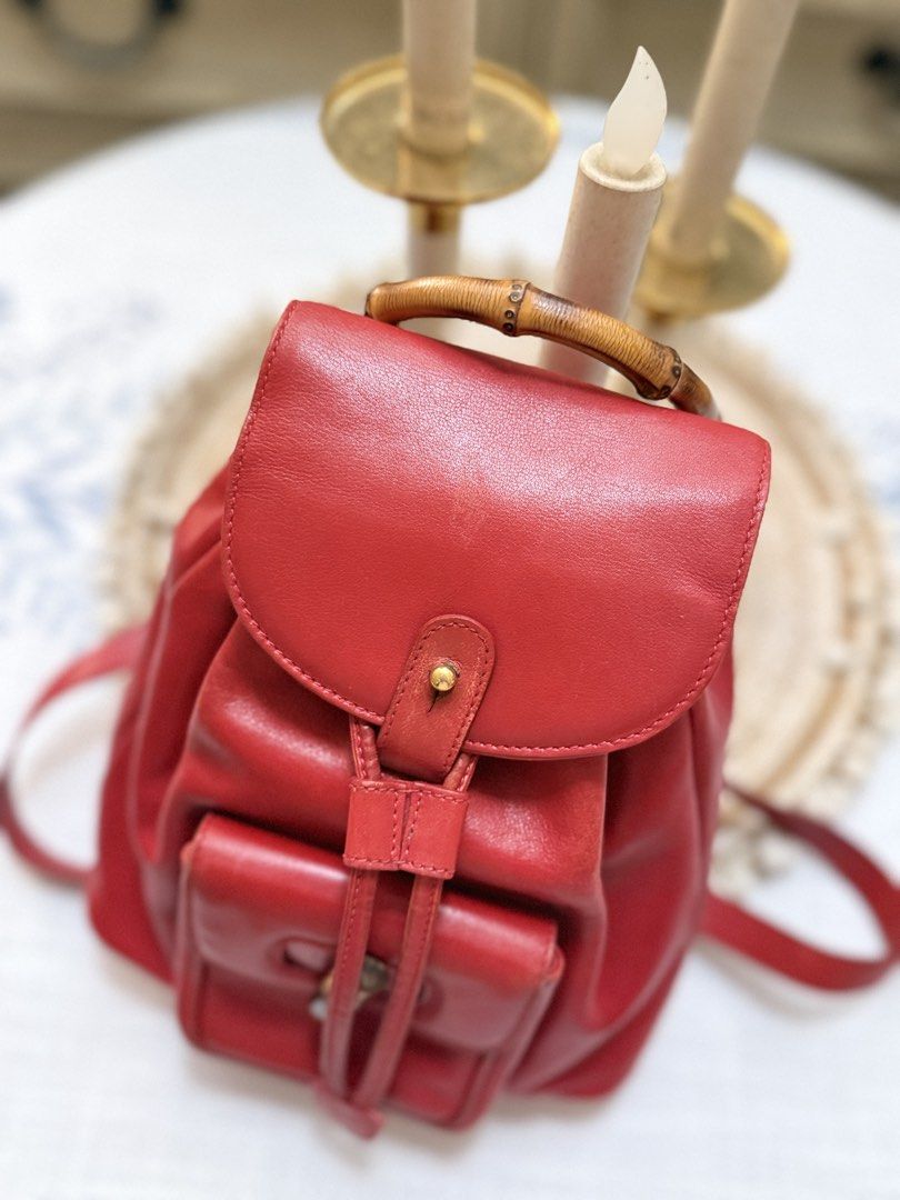 Gucci Calfskin Bamboo Drawstring Backpack Red (Category: Backpacks) located in Quezon City. Submitted by cndcvrtc (Listing ID 1465945877, Image 2). Description: Gucci red calfskin leather backpack. Bamboo top handle and front turn-lock pocket. Drawstring main closure with flap top and snap button. Adjustable red leather shoulder straps with gold-tone hardware. Classic vintage piece with rich red color and structured shape..