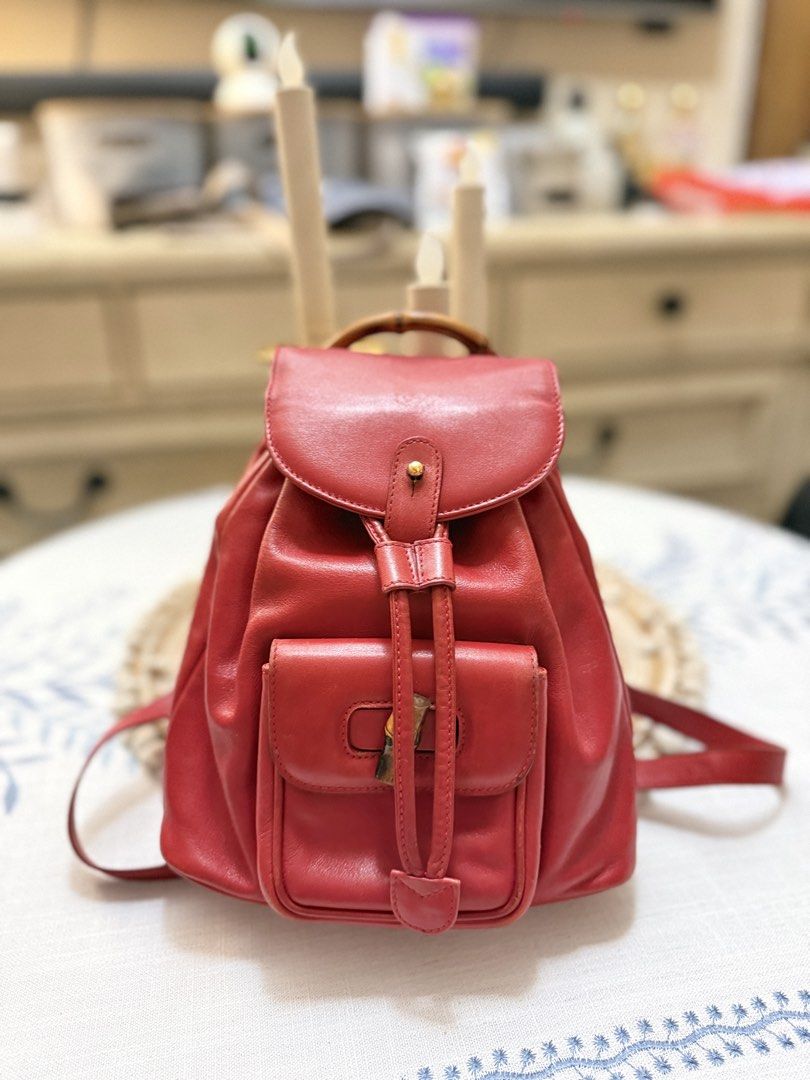 Gucci Calfskin Bamboo Drawstring Backpack Red (Category: Backpacks) located in Quezon City. Submitted by cndcvrtc (Listing ID 1465945877, Image 1). Description: Gucci red calfskin leather backpack. Bamboo top handle and front turn-lock pocket. Drawstring main closure with flap top and snap button. Adjustable red leather shoulder straps with gold-tone hardware. Classic vintage piece with rich red color and structured shape..