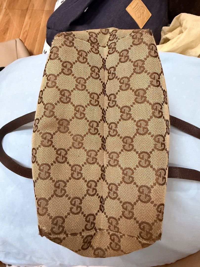 Gucci GG Monogram Canvas Tote Handbag (Category: Luxury Bags & Wallets) located in Caloocan City. Submitted by phiapitargue (Listing ID 1465849842, Image 3). Description: - Authentic Gucci monogram canvas handbag in brown and beige - Dual leather top handles for comfortable carrying - Secure zip closure across the top - Dark fabric interior lining with embossed leather serial number tag (124542 203937) - Compact and chic design, perfect for daily