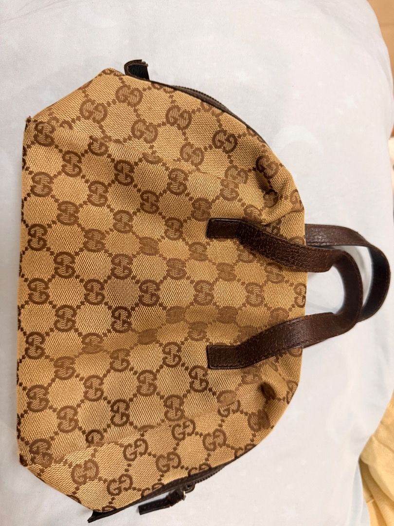 Gucci GG Monogram Canvas Tote Handbag (Category: Luxury Bags & Wallets) located in Caloocan City. Submitted by phiapitargue (Listing ID 1465849842, Image 1). Description: - Authentic Gucci monogram canvas handbag in brown and beige - Dual leather top handles for comfortable carrying - Secure zip closure across the top - Dark fabric interior lining with embossed leather serial number tag (124542 203937) - Compact and chic design, perfect for daily